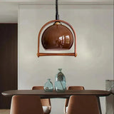 The dome in its wooden arch lit above a dining table with dark chairs
