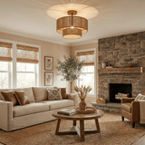 Jute ceiling light lit in a living room with a stone fireplace and a round table