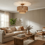 Two tier jute ceiling light above a sofa with a wood coffee table and dried stems