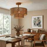 Jute ceiling light lit over a dining table with woven chairs and a tall window