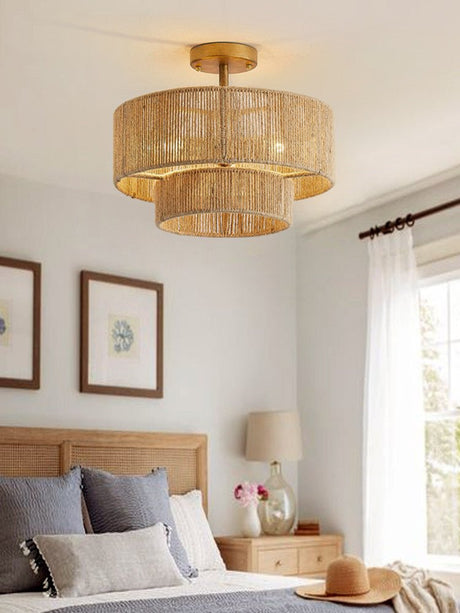 Jute ceiling light lit in a bedroom with a wood headboard and framed prints