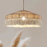 Jute pendant light lit in a pale interior