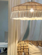 Jute pendant light switched on, the fringe lit from within