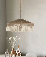 Jute pendant light hung beside an arched mirror