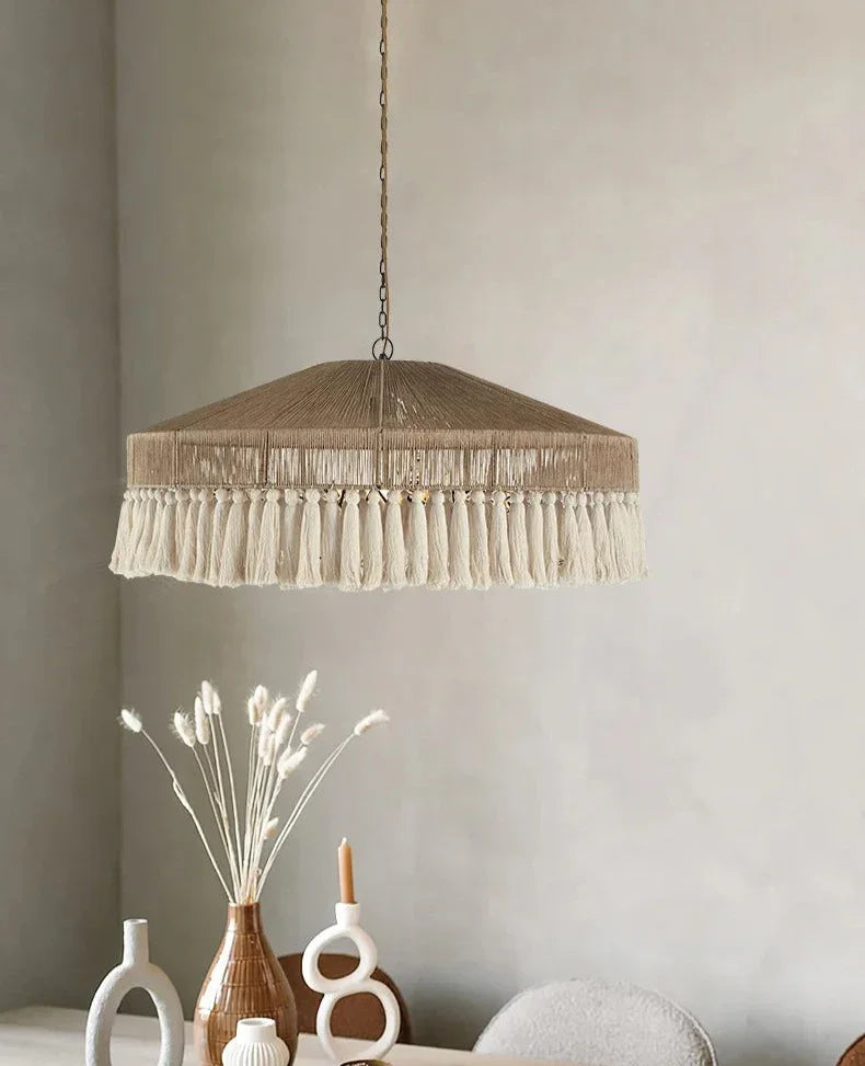 Jute pendant light hung beside an arched mirror