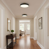 Black drum ceiling lights along a hallway with a console table