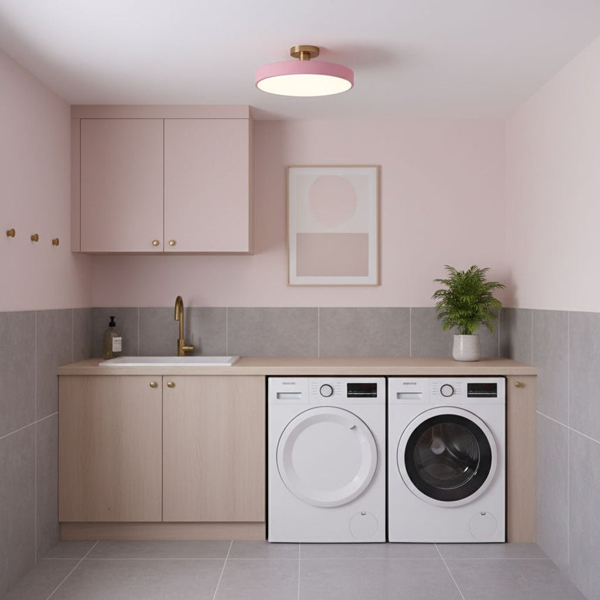 Pink drum ceiling light in a laundry room with a washer and dryer