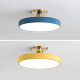Blue and yellow drum ceiling lights shown on a plain backdrop
