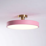 Pink drum ceiling light lit against a pale backdrop