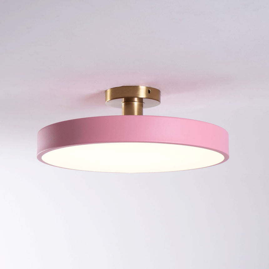 Pink drum ceiling light lit against a pale backdrop
