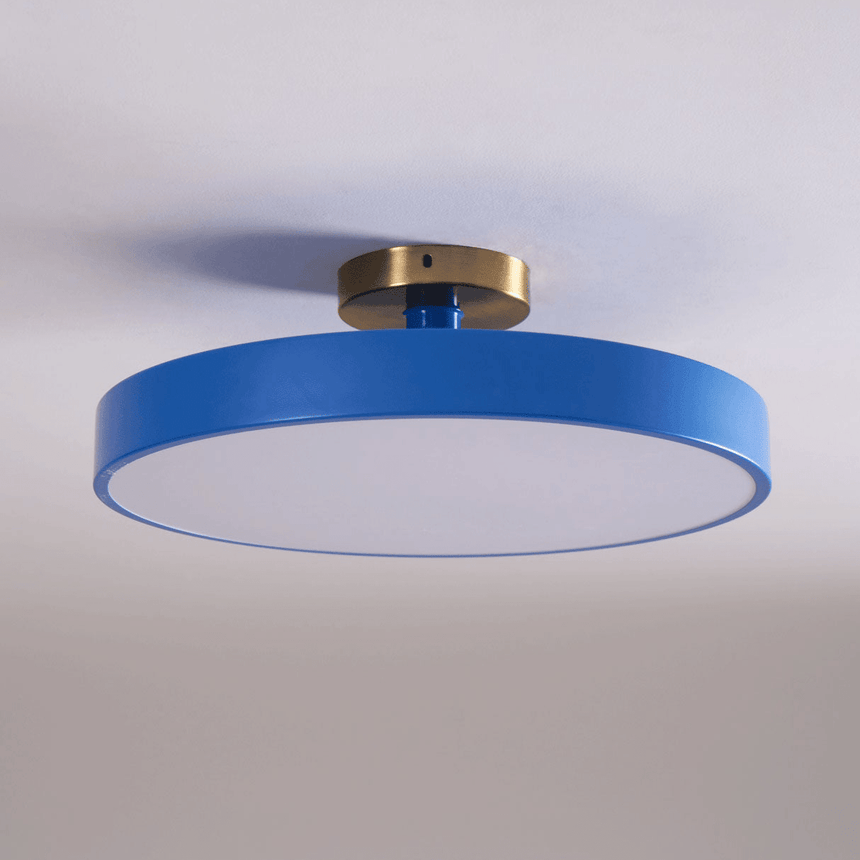 Blue drum ceiling light lit against a pale backdrop