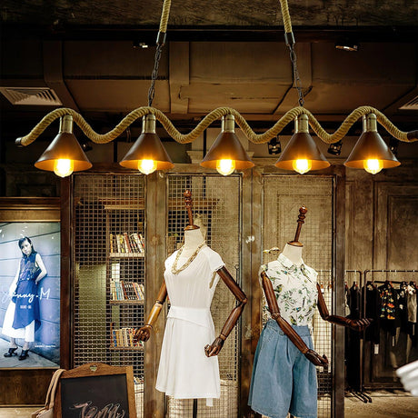 The fitting lit above a display rail and a shelf of folded goods