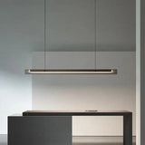 The lit bar hung above a kitchen counter beside tall cabinets