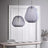 Two gray fabric lanterns hung at different heights in a pale room
