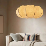 Ribbed silk lantern lit warm above a sofa