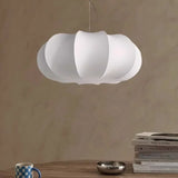 Lantern ceiling light in ribbed silk lit above a table