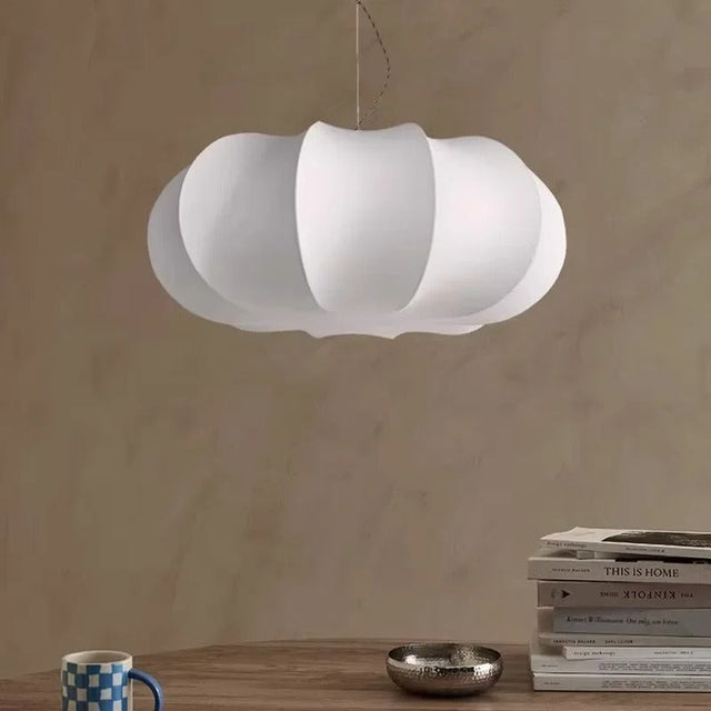 Lantern ceiling light in ribbed silk lit above a table