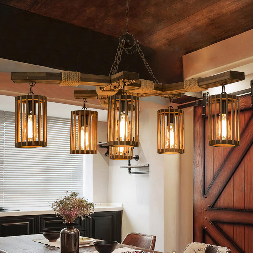 Chandelier lit next to a sliding barn door above a small table