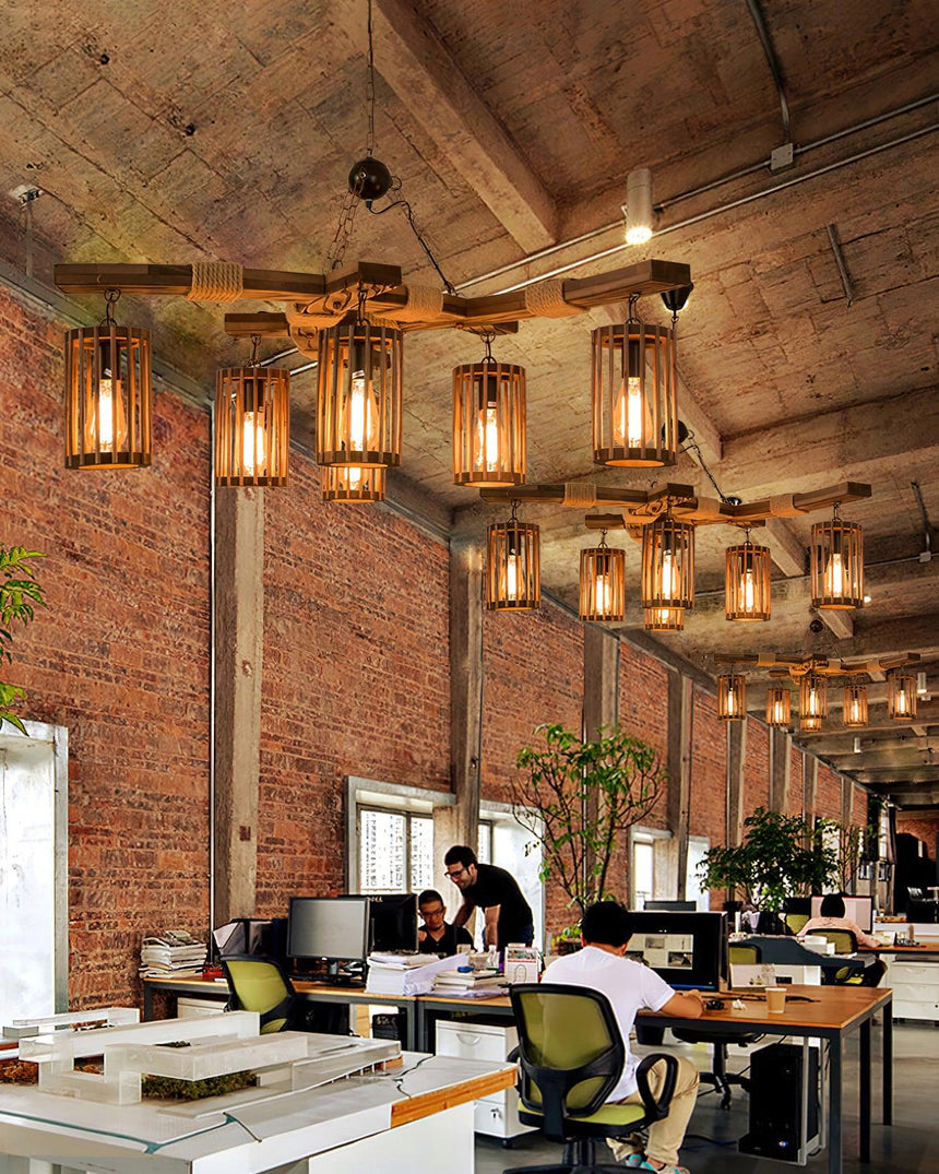A line of the chandeliers lit down a long room with brick and tables