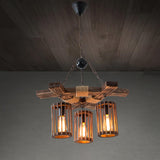 The six light chandelier lit warm against a dark plank ceiling