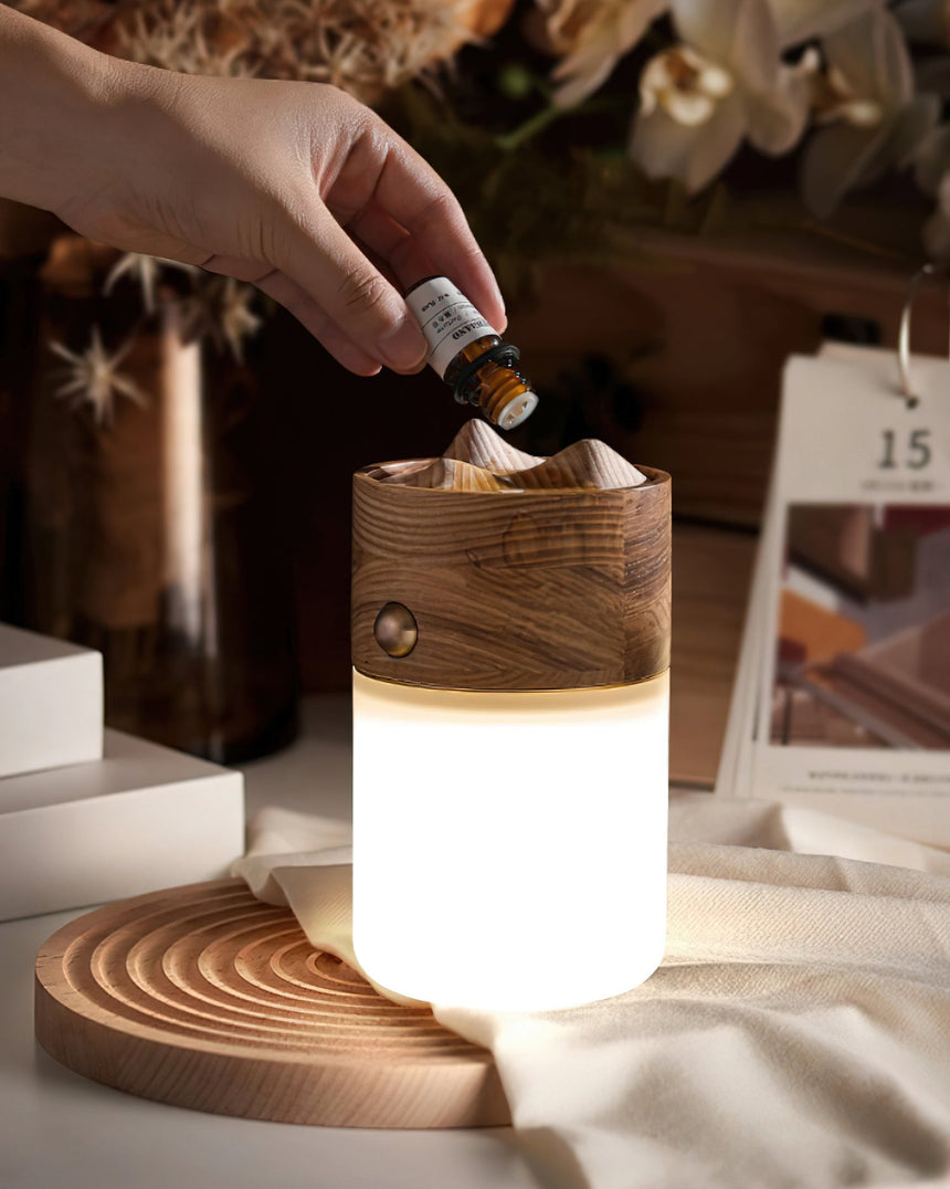Close view of a hand adding oil to the carved top of the lit lantern