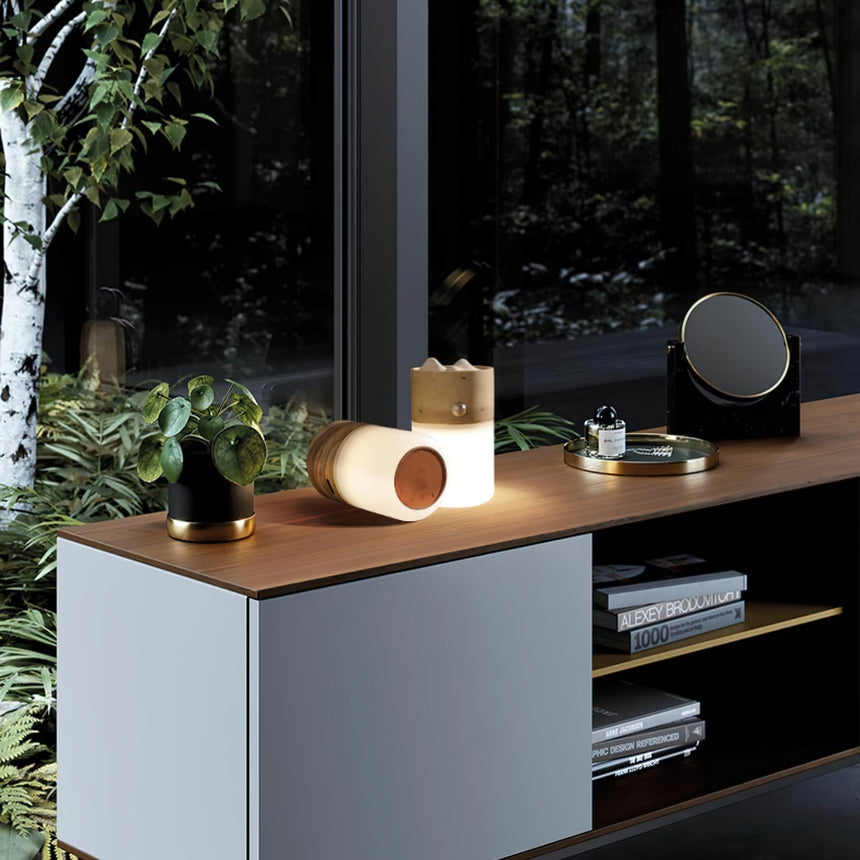 Lantern table lamp lying on a sideboard beside plants and a speaker