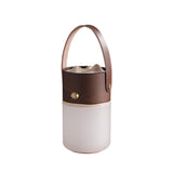Lantern table lamp in walnut with the leather strap, plain background
