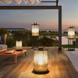 Lanterns lit under a pergola on a terrace facing the sea at sunset