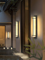 The lantern lit at an entry beside water and dark stone steps at night