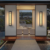 A pair lit either side of a timber gateway above a gravel entrance