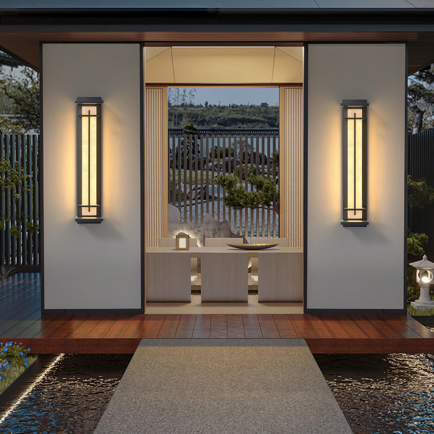 A pair lit either side of a timber gateway above a gravel entrance