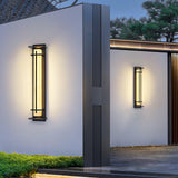Two lit on render piers in a clipped garden with a pale paved walk