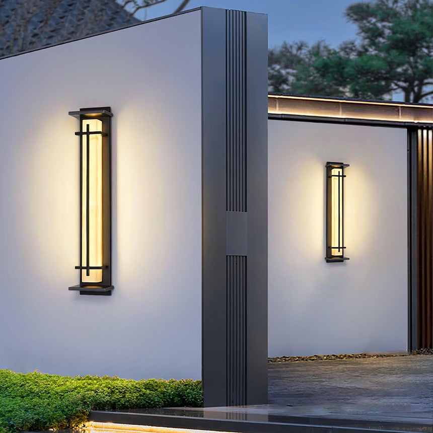 Two lit on render piers in a clipped garden with a pale paved walk