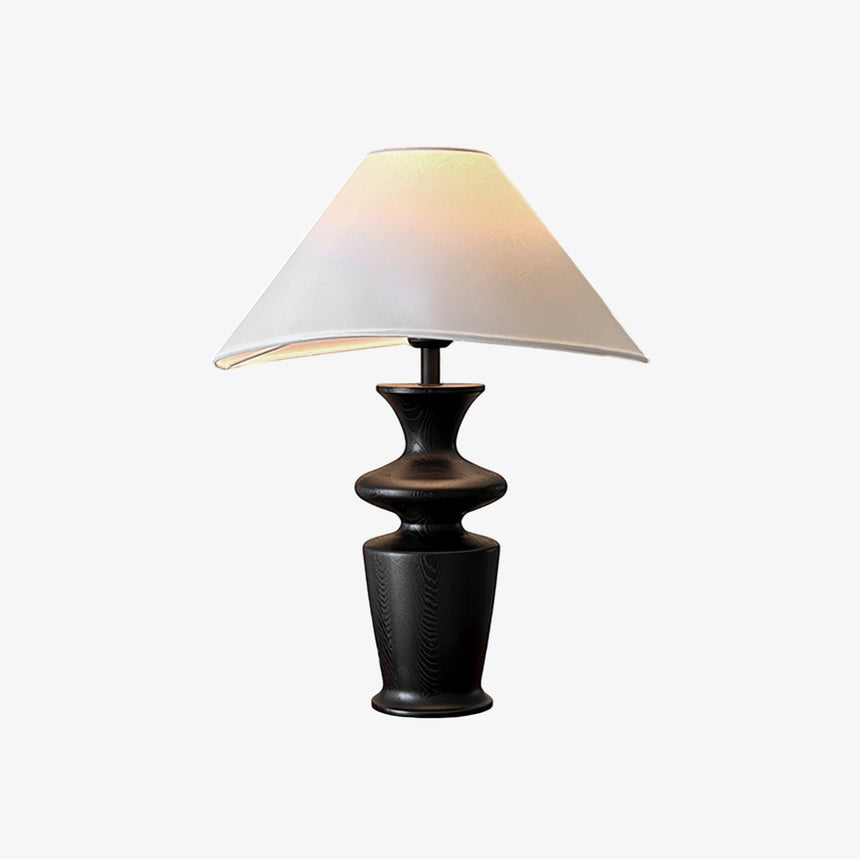 Large table lamp seen from the front, wide coolie shade over the black urn