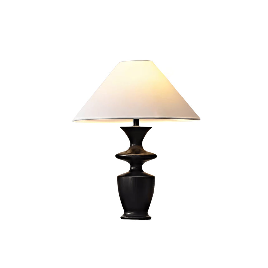 Large table lamp seen in full, white coolie shade above the black urn base