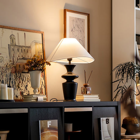 Large table lamp seen from the side, the shade wide and almost flat
