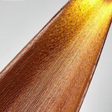 The dried cocoa leaf seen close, its veins glowing amber