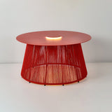 The coffee toned cord base of the table with the light under the top