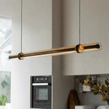 The lit glass bar hung across a wide kitchen above the worktop