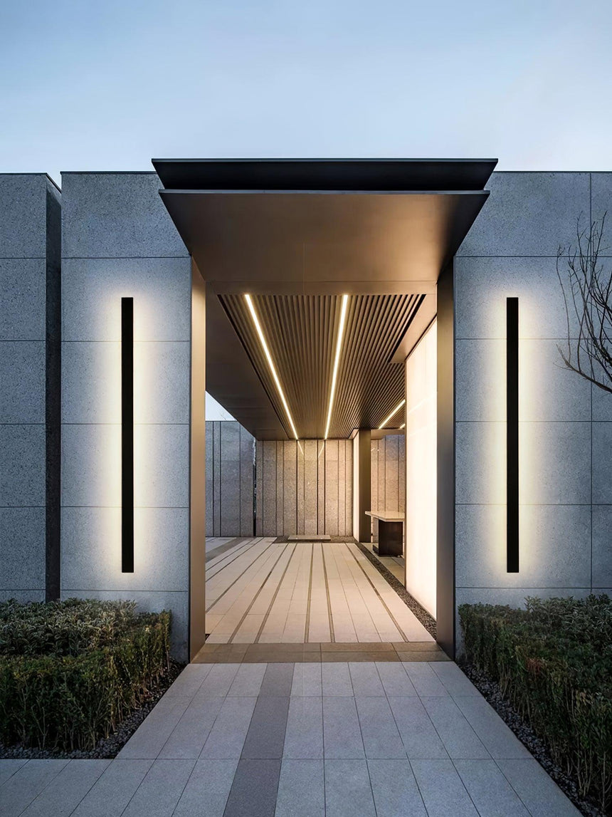 Two strips lit on the pillars of a covered walkway leading to a front door