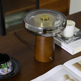 The smoked glass disc of the LED table lamp seen from slightly above