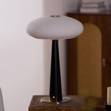 LED table lamp lit on a plinth in a dining corner beside a chair