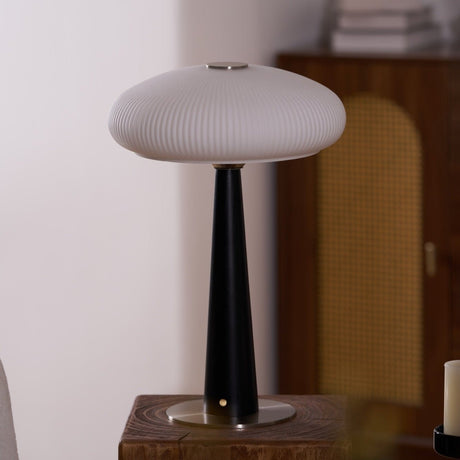 LED table lamp lit on a plinth in a dining corner beside a chair