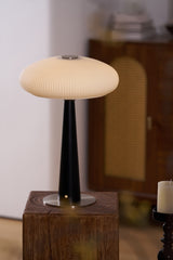 LED table lamp lit and seen from a low angle on a plinth