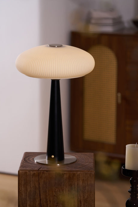 LED table lamp lit and seen from a low angle on a plinth