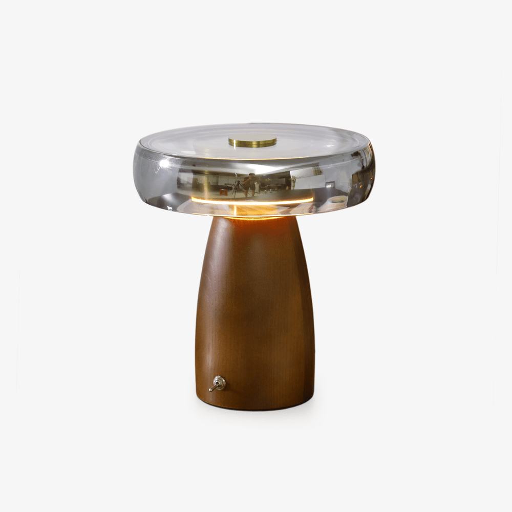 LED table lamp with a smoked glass disc on a walnut base, plain background