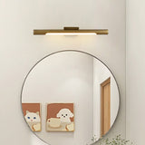 Brass tube lit above a round mirror beside two framed animal prints