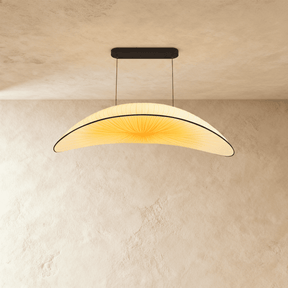 A wide shallow cream fabric shade curved like a hull, hung on two fine cables