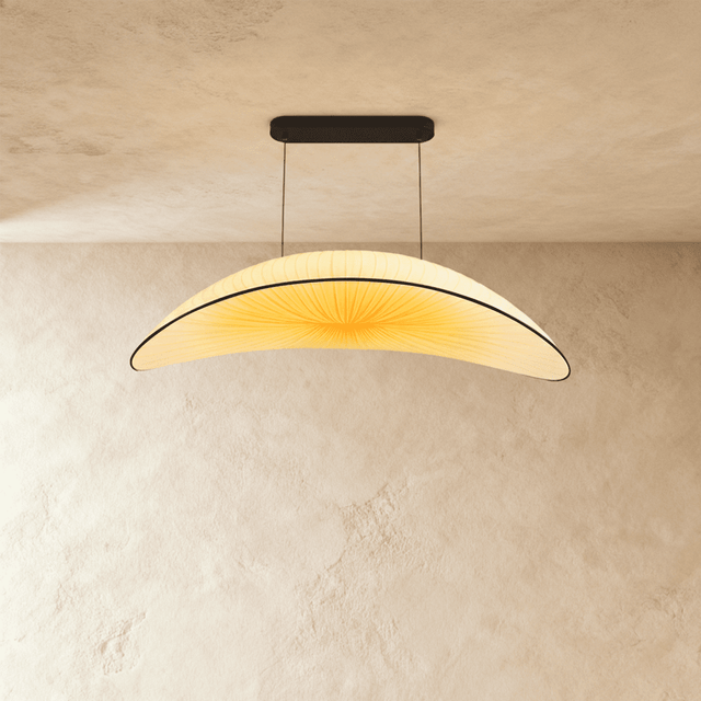 A wide shallow cream fabric shade curved like a hull, hung on two fine cables