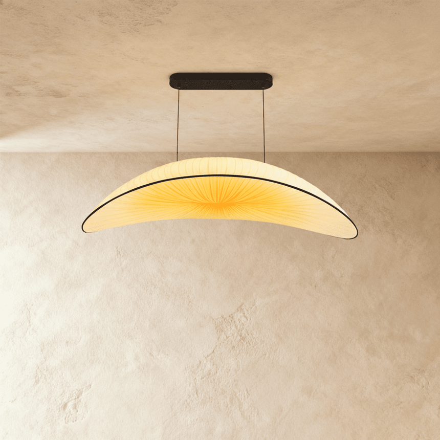 A wide shallow cream fabric shade curved like a hull, hung on two fine cables